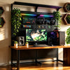 KOKO heavy-duty modular pegboard desk setup with integrated cable management and RGB lighting in an atmospheric, neon-lit creative studio and gaming battlestation at night.