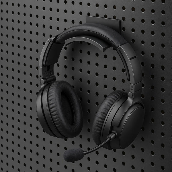 Black gaming headset resting on a KOKO pegboard headset holder, with the earcups hanging below.