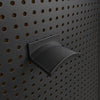 Black KOKO headset holder mounted on a black round-hole pegboard, showing the curved headband support.